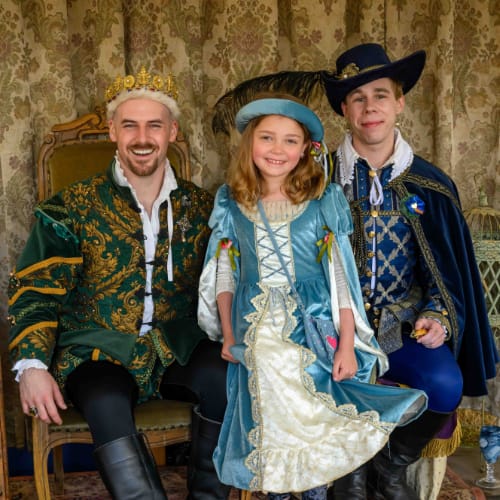 A young woman dressed as a princess posing with King James and Sir George Villars