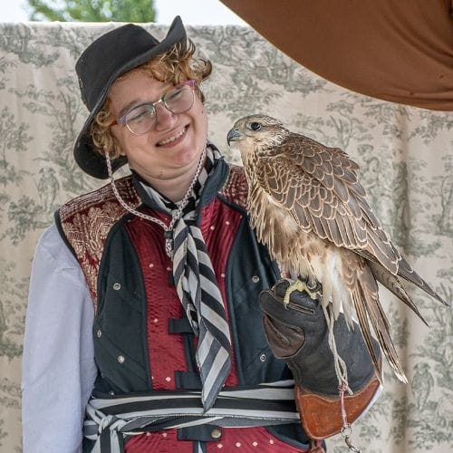 A woman with a hawk on her arm